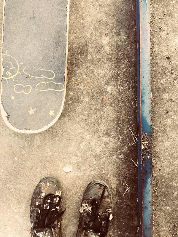 Shoes and a skateboard in sepia tone